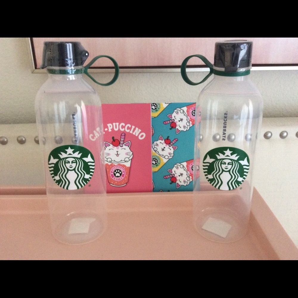 2 Starbucks plastic water bottles and 2 notepads